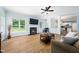 Bright living room features a fireplace, ceiling fan and hardwood floors; open to the kitchen at 112 Sterling Ridge Way, Cary, NC 27519