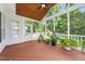 Screened-in porch featuring a wood ceiling, red painted wood floor and decorative plants at 112 Sterling Ridge Way, Cary, NC 27519