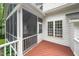 Screened-in porch featuring a red painted wood floor, screened in door and white walls at 112 Sterling Ridge Way, Cary, NC 27519