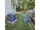 Backyard showcasing an AC unit and raised garden beds near a wooden fence and green surroundings at 119 Comanche Dr, Louisburg, NC 27549