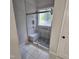 Walk in shower with seamless glass door features built-in bench and decorative window at 119 Comanche Dr, Louisburg, NC 27549