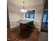 Eat-in kitchen features a modern bar, dining space, hardwood floors and neutral paint at 119 Comanche Dr, Louisburg, NC 27549