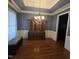Dining room featuring blue painted walls, coffered ceilings, hardwood floors, and a dark wood china cabinet at 119 Comanche Dr, Louisburg, NC 27549
