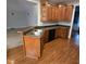 Kitchen featuring wooden cabinets, hardwood floors, stainless steel double sink and black appliances at 119 Comanche Dr, Louisburg, NC 27549