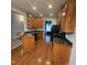 Spacious kitchen with wood cabinets, hardwood floors, and black appliances, ready for cooking at 119 Comanche Dr, Louisburg, NC 27549