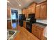 Well lit kitchen with wooden cabinets, hardwood floor, and gray countertops at 119 Comanche Dr, Louisburg, NC 27549