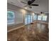 Bright living room with tile flooring, multiple windows, and ceiling fans at 119 Comanche Dr, Louisburg, NC 27549