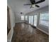 Bright living room features tile flooring, multiple windows, and ceiling fans at 119 Comanche Dr, Louisburg, NC 27549