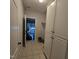 Mudroom featuring tile flooring, white cabinets, and a view into the garage at 119 Comanche Dr, Louisburg, NC 27549