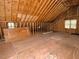 Unfinished attic space with exposed wood framing, a window and duct work at 119 Long Shadow Ln, Cary, NC 27518