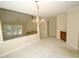 Open concept dining area featuring chandelier and easy access to the living room at 119 Long Shadow Ln, Cary, NC 27518