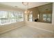 Formal dining room with chandelier looks into sunny living space through half-wall at 119 Long Shadow Ln, Cary, NC 27518
