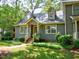 Charming home featuring dormer windows, well-maintained landscaping, and a brick walkway at 119 Long Shadow Ln, Cary, NC 27518