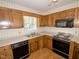 U-shaped kitchen with laminate floor and countertops features stainless steel appliances at 119 Long Shadow Ln, Cary, NC 27518