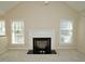 Living room featuring a black fireplace, ceiling fan and abundant natural light at 119 Long Shadow Ln, Cary, NC 27518