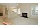Bright living room with fireplace, neutral carpet, and open floor plan at 119 Long Shadow Ln, Cary, NC 27518