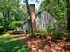 The rear and side of the home is surrounded by mature trees and shrubbery at 119 Long Shadow Ln, Cary, NC 27518