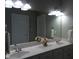 Bathroom with double vanity and large mirror with decorative lighting at 12 Crail Ct, Durham, NC 27712