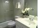 Bathroom with a neutral vanity sink, white ceramic toilet, and shower with glass door at 12 Crail Ct, Durham, NC 27712