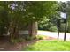 Royal Troon neighborhood entrance sign with mature landscaping and a street sign at 12 Crail Ct, Durham, NC 27712