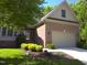 Charming brick home featuring an attached garage and well-maintained landscaping in the front yard at 12 Crail Ct, Durham, NC 27712
