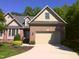 Beautiful two-story brick home with a well-manicured lawn and attached garage at 12 Crail Ct, Durham, NC 27712