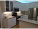 Updated kitchen with white cabinets, stainless steel appliances, and hardwood floors at 12 Crail Ct, Durham, NC 27712