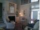 Inviting living room with fireplace, hardwood floors, high ceilings, and lots of natural light at 12 Crail Ct, Durham, NC 27712