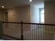Loft area with neutral carpeting and view to the window across the railing at 12 Crail Ct, Durham, NC 27712