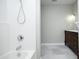 Bright bathroom featuring a shower and a vanity sink with dark wood cabinetry and a decorative mirror at 120 Jennel Way, Durham, NC 27707