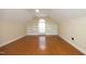 Bright bedroom with hardwood floors, built-in shelving and a large window for plenty of natural light at 120 Jennel Way, Durham, NC 27707