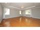 Spacious bedroom with tray ceilings, hardwood floors, neutral paint and large windows with curtains at 120 Jennel Way, Durham, NC 27707