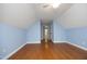 Bedroom with blue accent wall, wood floors and ceiling fan at 120 Jennel Way, Durham, NC 27707