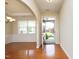 Open foyer view showcasing gleaming hardwood floors and an arched doorway leading to the dining room at 120 Jennel Way, Durham, NC 27707