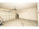 A spacious garage with concrete flooring and an automatic garage door, offering ample storage and parking at 120 Jennel Way, Durham, NC 27707