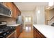 Modern kitchen with stainless steel appliances, gas stove, island, and hardwood floors at 120 Jennel Way, Durham, NC 27707