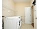 Functional laundry room equipped with a washer, dryer, and wire shelving for ample storage at 120 Jennel Way, Durham, NC 27707