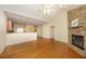 Spacious living room open to kitchen with stone fireplace and hardwood floors at 120 Jennel Way, Durham, NC 27707