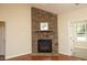 Living room with a stone fireplace and hardwood floors with entry to sunroom at 120 Jennel Way, Durham, NC 27707