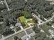 Aerial view shows the property outlined, highlighting home, basketball court, yard and driveway at 123 Scheer Ave, Durham, NC 27703