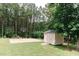 A basketball court and storage shed are featured in this large backyard at 123 Scheer Ave, Durham, NC 27703