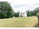 Expansive back yard view featuring the back of the two-story home and a shed at 123 Scheer Ave, Durham, NC 27703