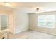 Cozy bedroom with carpet, ceiling fan, and large window providing natural light and a tranquil space at 123 Scheer Ave, Durham, NC 27703