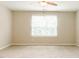 Spacious bedroom with carpet, ceiling fan, and window, offering comfort and natural light for relaxation at 123 Scheer Ave, Durham, NC 27703