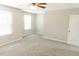 Inviting bedroom with carpet, ceiling fan, windows, and door leading to other rooms, creating a cozy retreat at 123 Scheer Ave, Durham, NC 27703