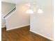 Open dining area with wood floors, traditional lighting fixture and stairs to second floor at 123 Scheer Ave, Durham, NC 27703