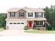 Charming two-story home with a bright red front door and well-manicured landscaping at 123 Scheer Ave, Durham, NC 27703