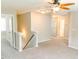 Upstairs hallway with neutral carpet, staircase, and multiple doors leading to other rooms at 123 Scheer Ave, Durham, NC 27703