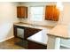 Bright kitchen features stainless steel dishwasher, plenty of counter space, and dark brown cabinets offering ample storage at 123 Scheer Ave, Durham, NC 27703