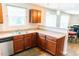 Well-lit kitchen with stainless steel appliances, plenty of counter space, and dark brown cabinets with natural lighting at 123 Scheer Ave, Durham, NC 27703